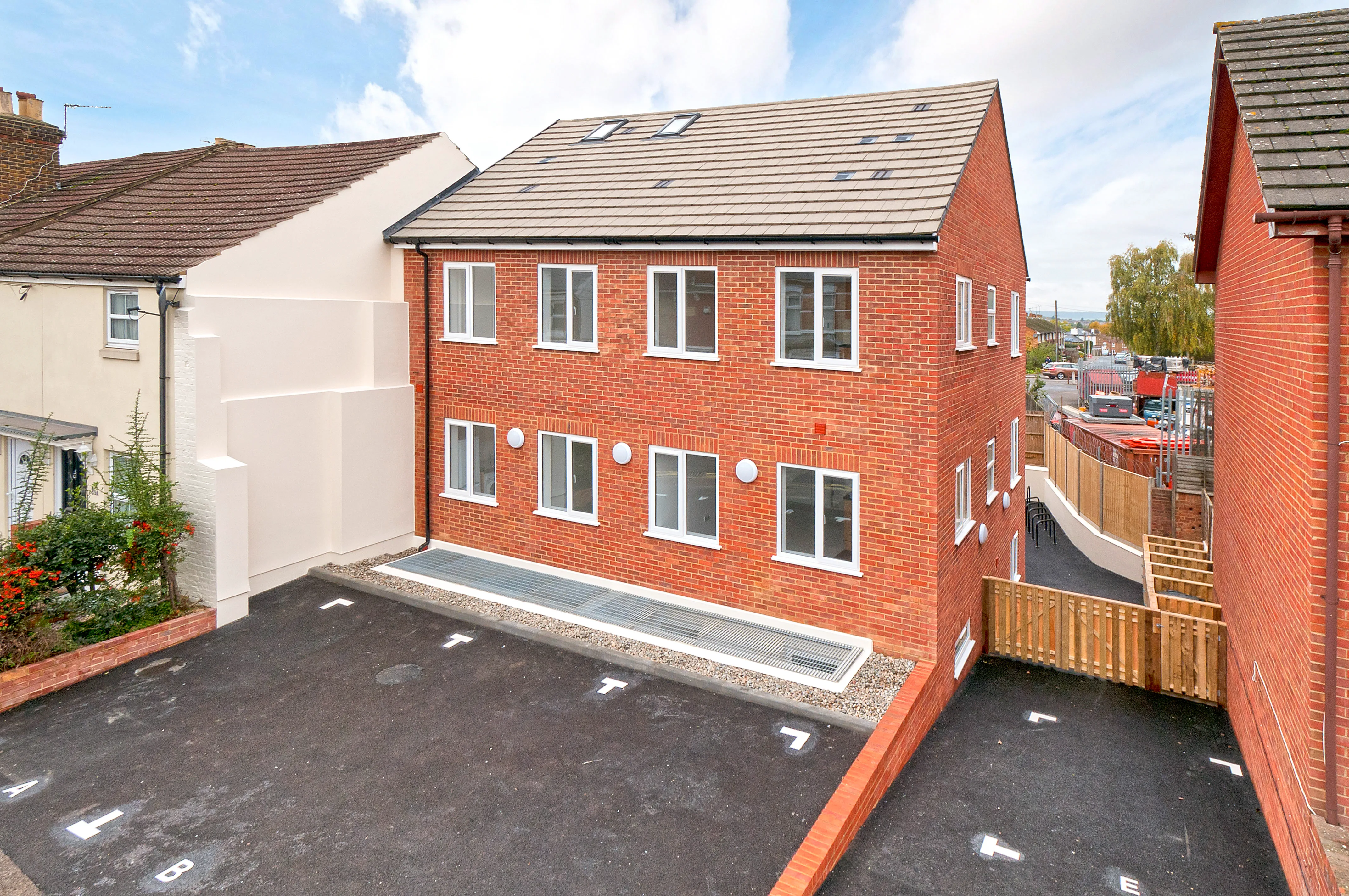 a red brick house with a black roof