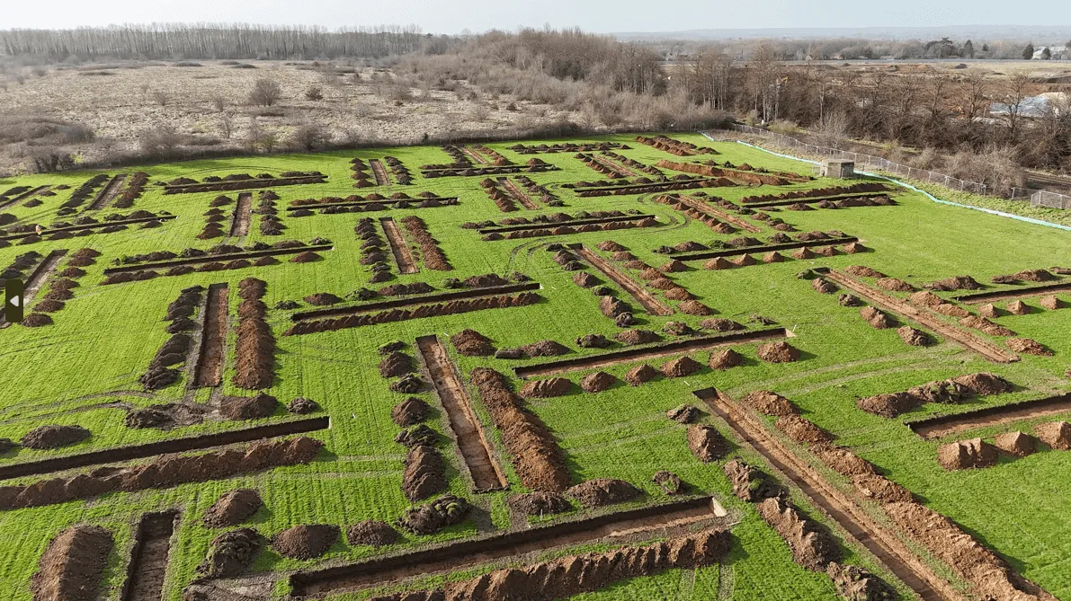 An aerial view of a field with a maze in the middle of it.